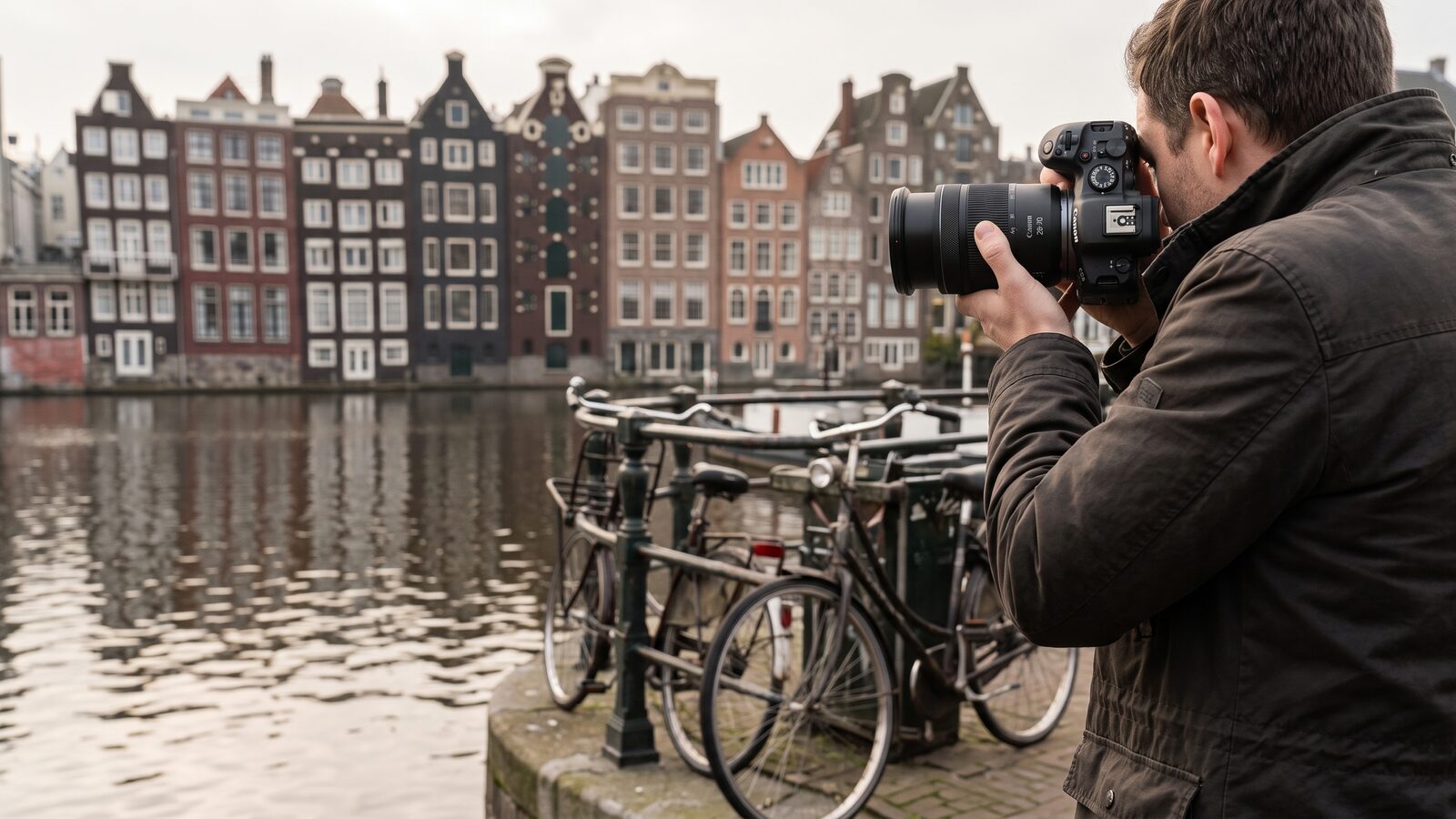 A photographer framing Amsterdam canal houses with a Canon R6 Mark II and RF 28-70mm F2.8 rented from FotoRent
